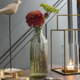 The MOUSSE vase is a charming bottle-shaped vase made of matte glass and coated in an elegant green color.